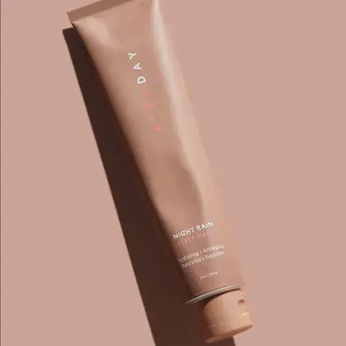 Airyday Night Rain sleep-mask tube on a dusty-rose surface